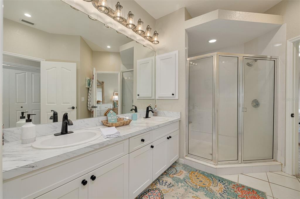8246 Aquila Street Port Richey, FL 34668 - Photo 21 of 43 a bathroom with a double vanity sink mirror and