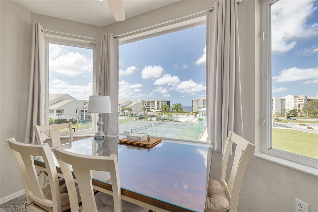 8246 Aquila Street Port Richey, FL 34668 - Photo 23 of 43 a dining room with furniture water view and a floor to ceiling window