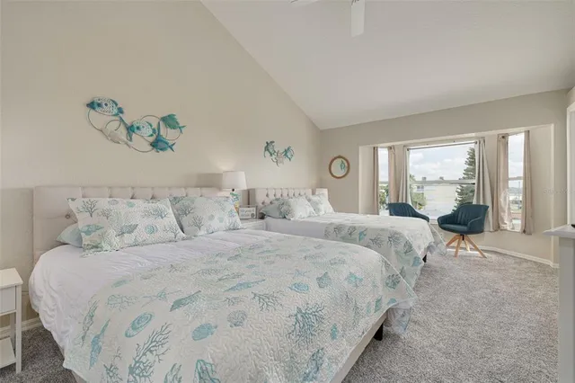 a bedroom with a bed and a flat tv screen on dresser