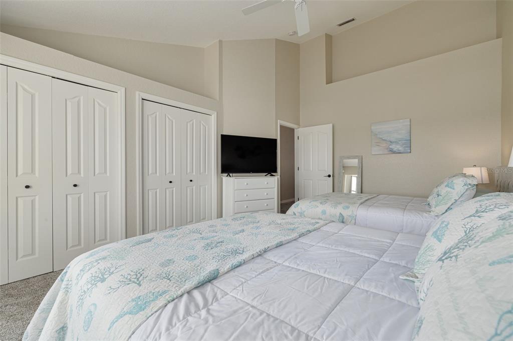 8246 Aquila Street Port Richey, FL 34668 - Photo 25 of 43 a bedroom with a bed and a flat tv screen on dresser
