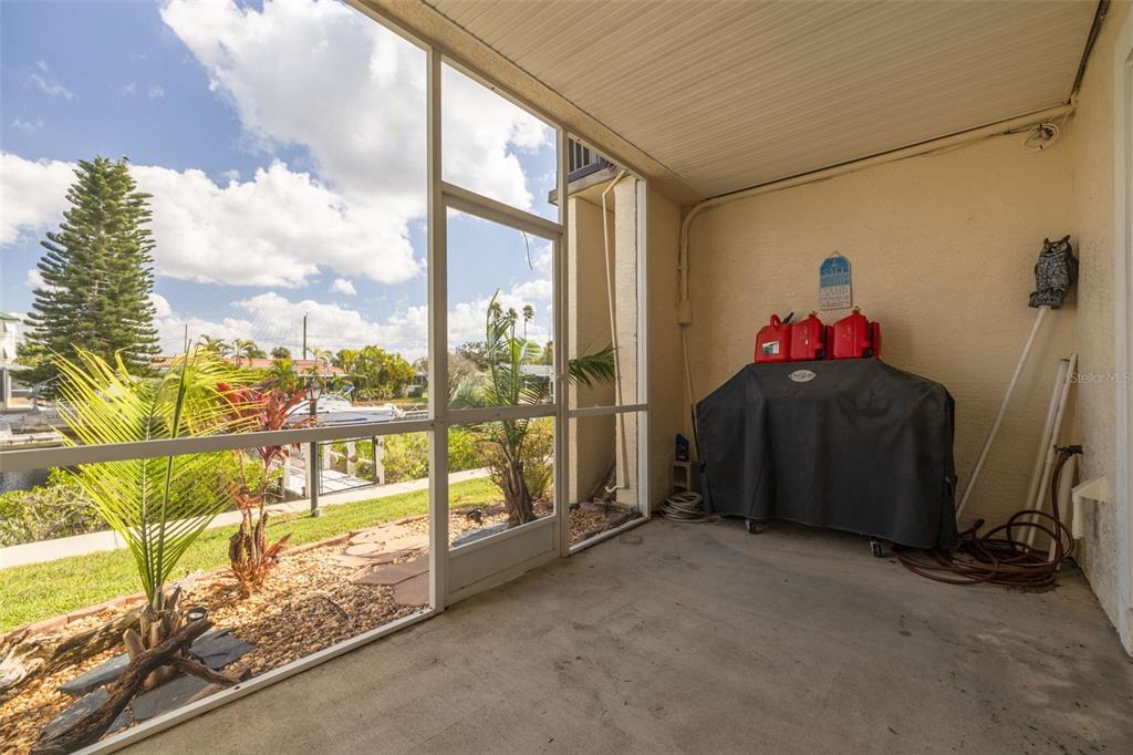 8246 Aquila Street Port Richey, FL 34668 - Photo 29 of 43 a living room with furniture and a floor to ceiling window
