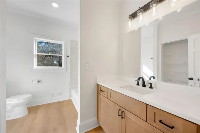 an empty room with a ceiling fan and wooden floor