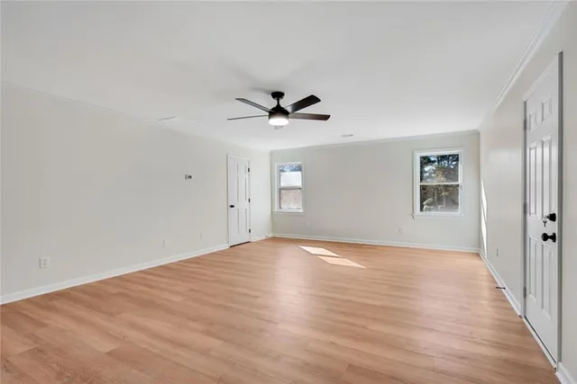a view of an empty room with a fireplace and a window