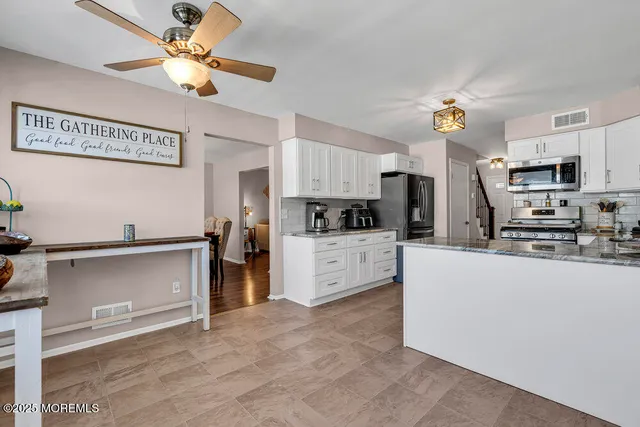 a kitchen with stainless steel appliances cabinets a sink and a stove