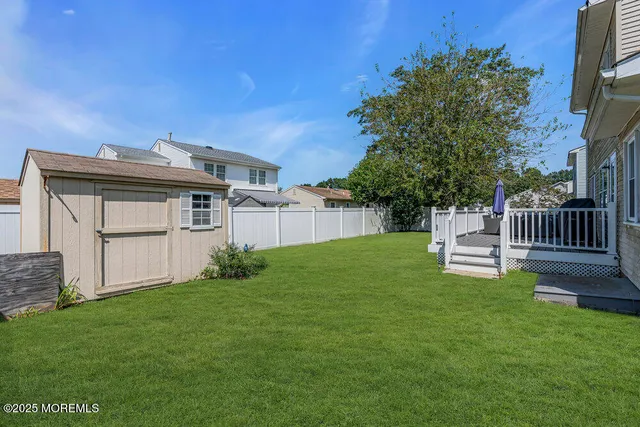 a view of a house with a yard and a garden