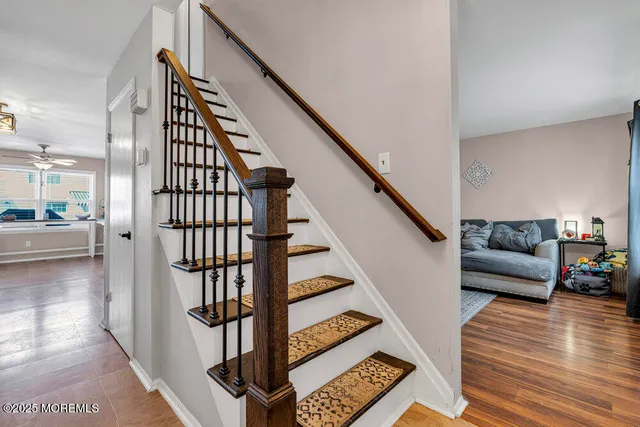 a view of entryway and hall with wooden floor