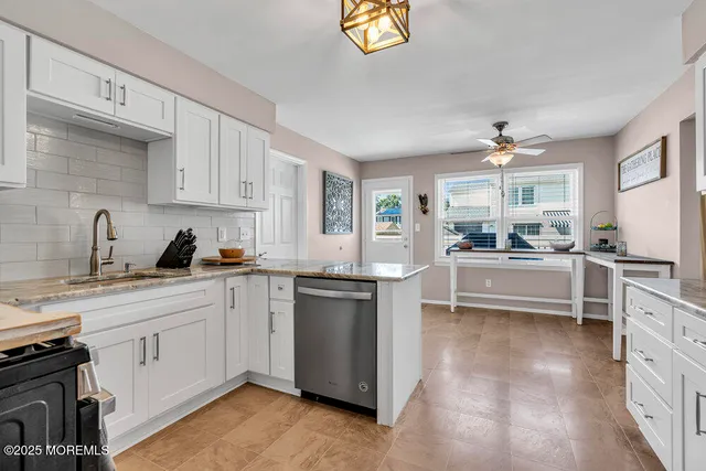 a kitchen with cabinets a sink and appliances