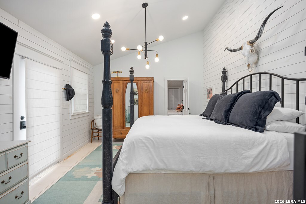 121 Simpson Road Comfort, TX 78013 - Photo 14 of 44 a spacious bedroom with a bed a mirror on the dresser and a window