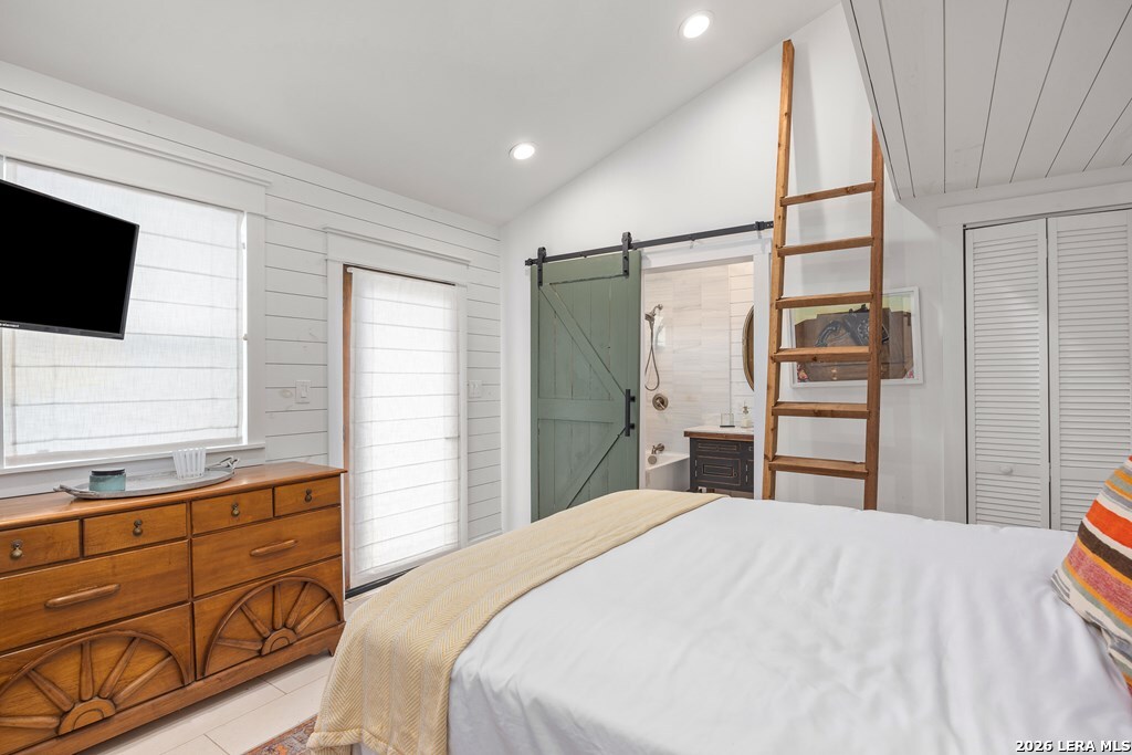 121 Simpson Road Comfort, TX 78013 - Photo 19 of 44 a bedroom with a bed and a flat screen tv