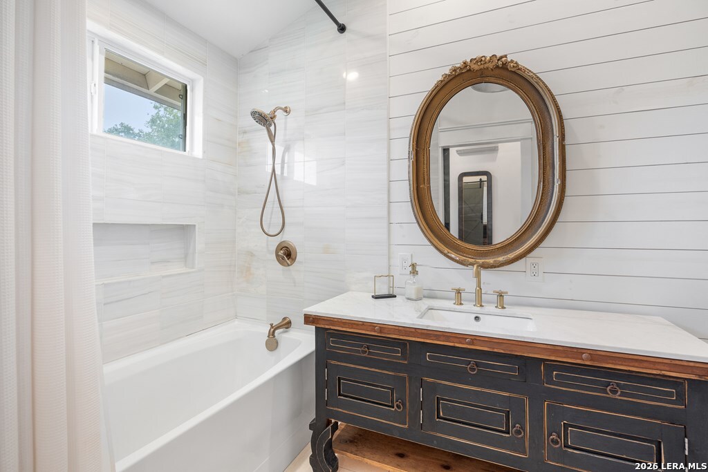121 Simpson Road Comfort, TX 78013 - Photo 20 of 44 a bathroom with a sink a bathtub and a mirror