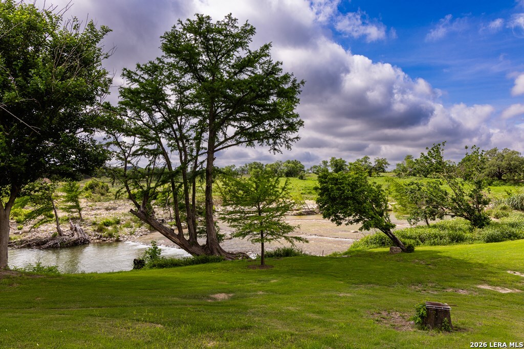 121 Simpson Road Comfort, TX 78013 - Photo 2 of 44 a view of a lake from a garden