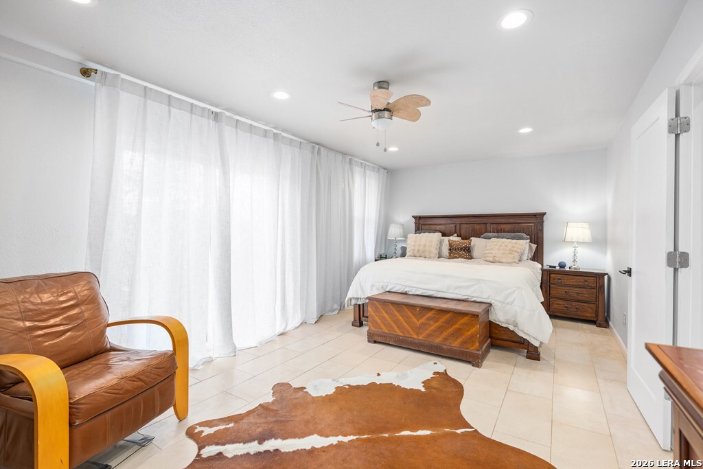 121 Simpson Road Comfort, TX 78013 - Photo 24 of 44 a bedroom with a bed and wooden floor