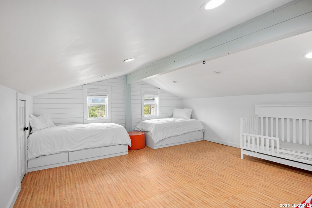 121 Simpson Road Comfort, TX 78013 - Photo 28 of 44 a bedroom with a bed and wooden floor