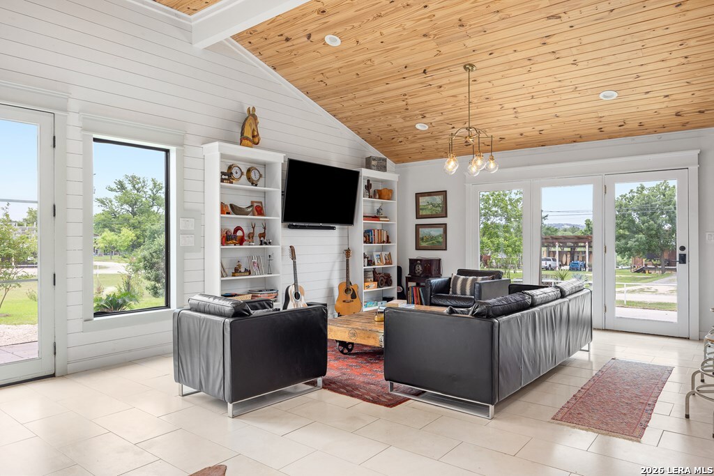 121 Simpson Road Comfort, TX 78013 - Photo 6 of 44 a living room with furniture a flat screen tv and a floor to ceiling window