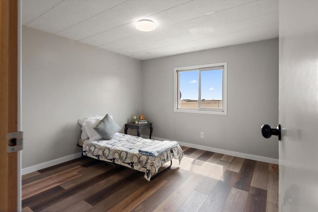 37155 East Jones Road Yoder, CO 80864 - Photo 15 of 48 a bedroom with a bed and wooden floor