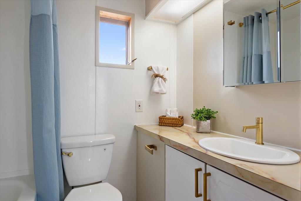37155 East Jones Road Yoder, CO 80864 - Photo 32 of 48 a bathroom with a granite countertop toilet sink and mirror