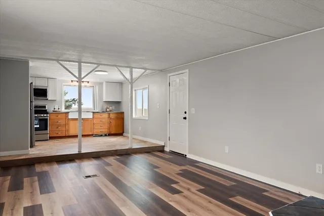 a view of a room with wooden floor and window
