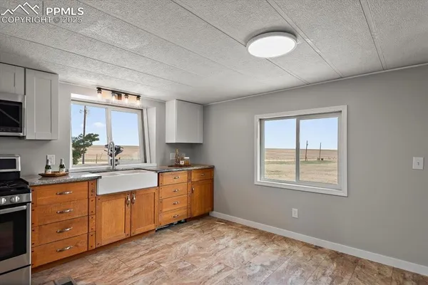 a kitchen with stainless steel appliances granite countertop a stove a sink and a refrigerator