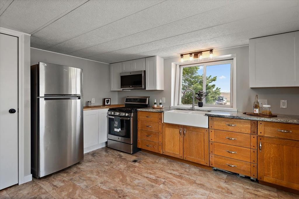 37155 East Jones Road Yoder, CO 80864 - Photo 10 of 48 a kitchen with stainless steel appliances a refrigerator sink and microwave