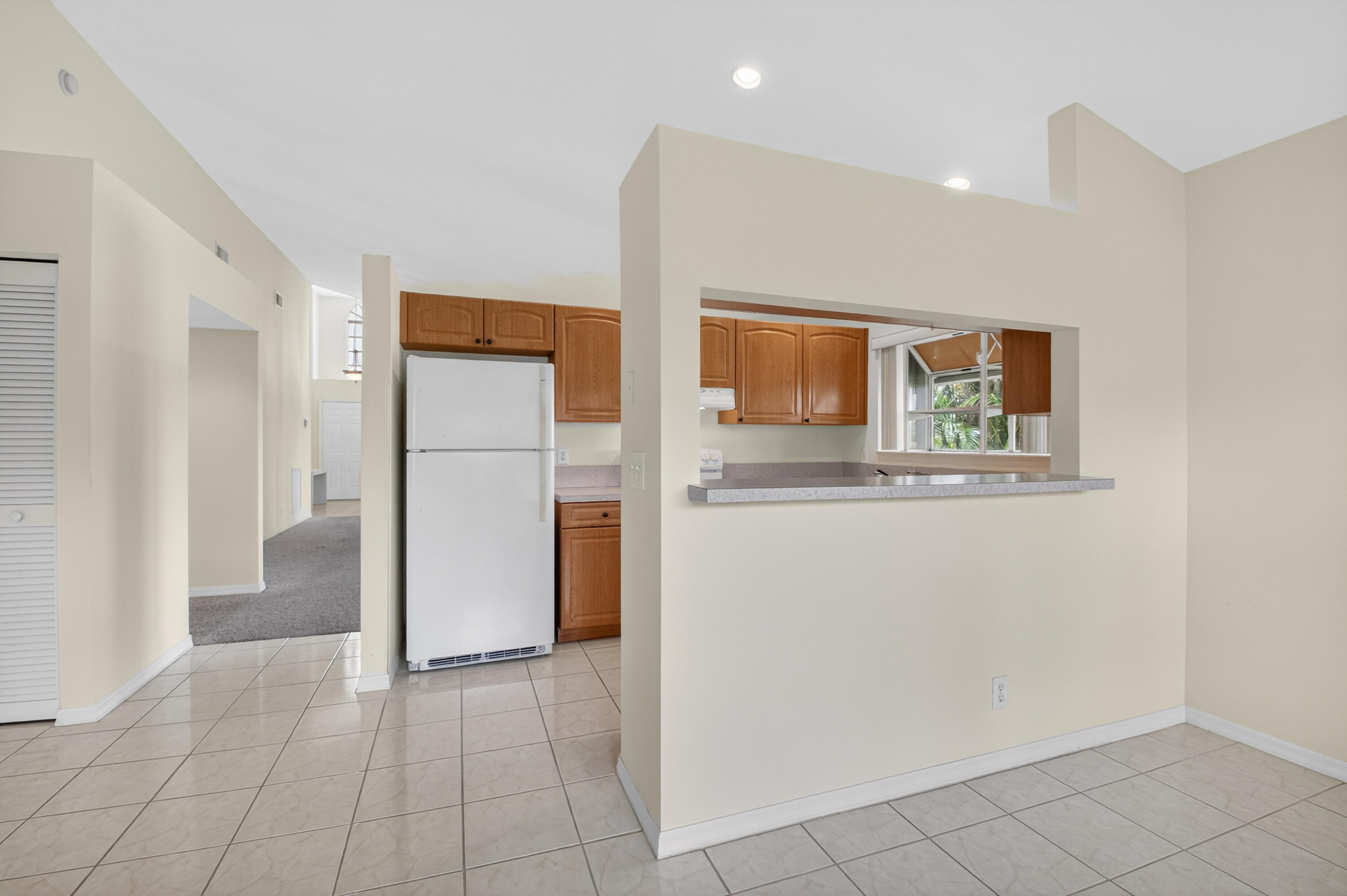 11151 Autoro Court Boca Raton, FL 33498 - Photo 13 of 70 a view of a refrigerator in kitchen and a window