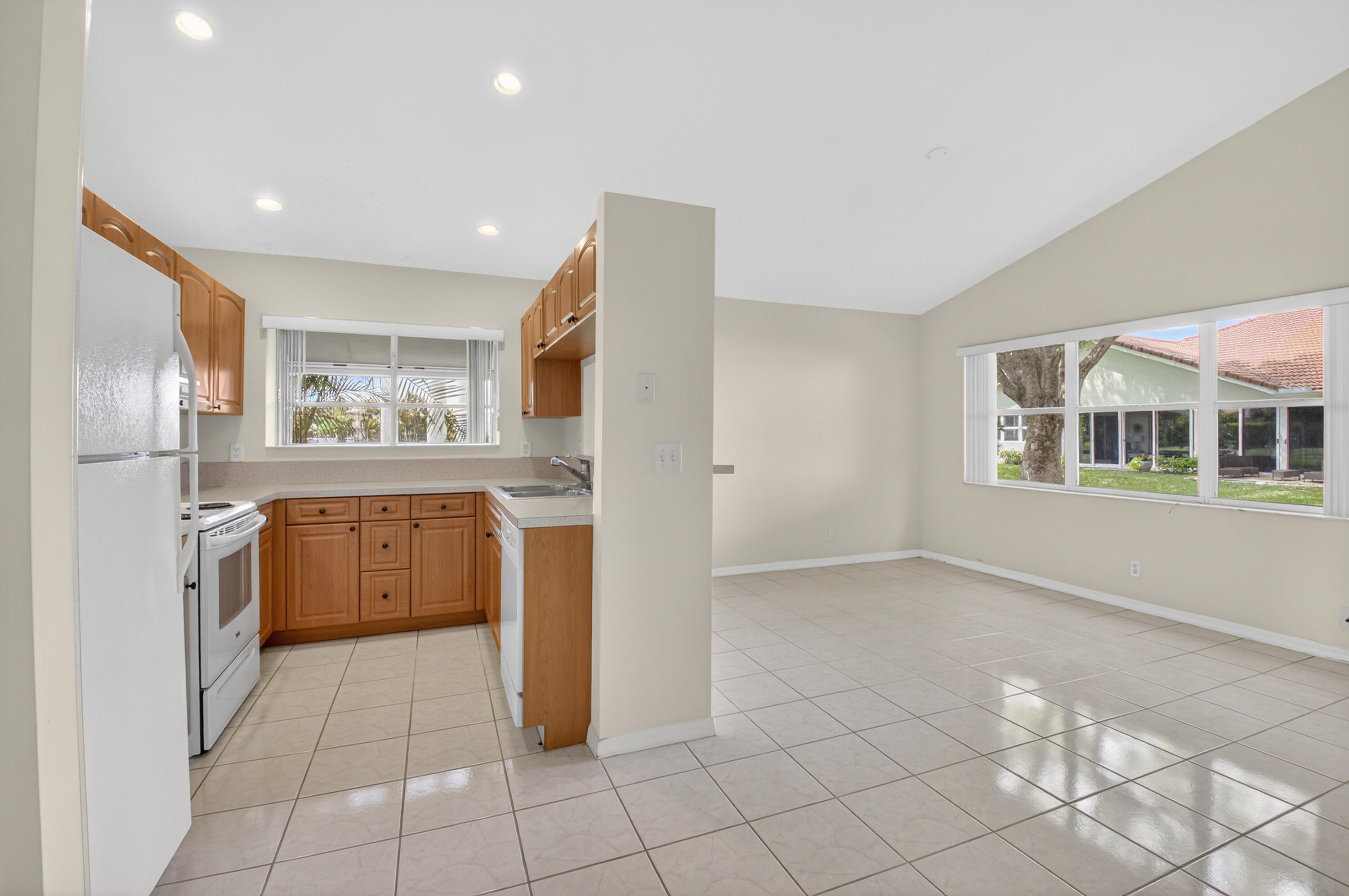 11151 Autoro Court Boca Raton, FL 33498 - Photo 15 of 70 a kitchen with a refrigerator a stove top oven and a refrigerator