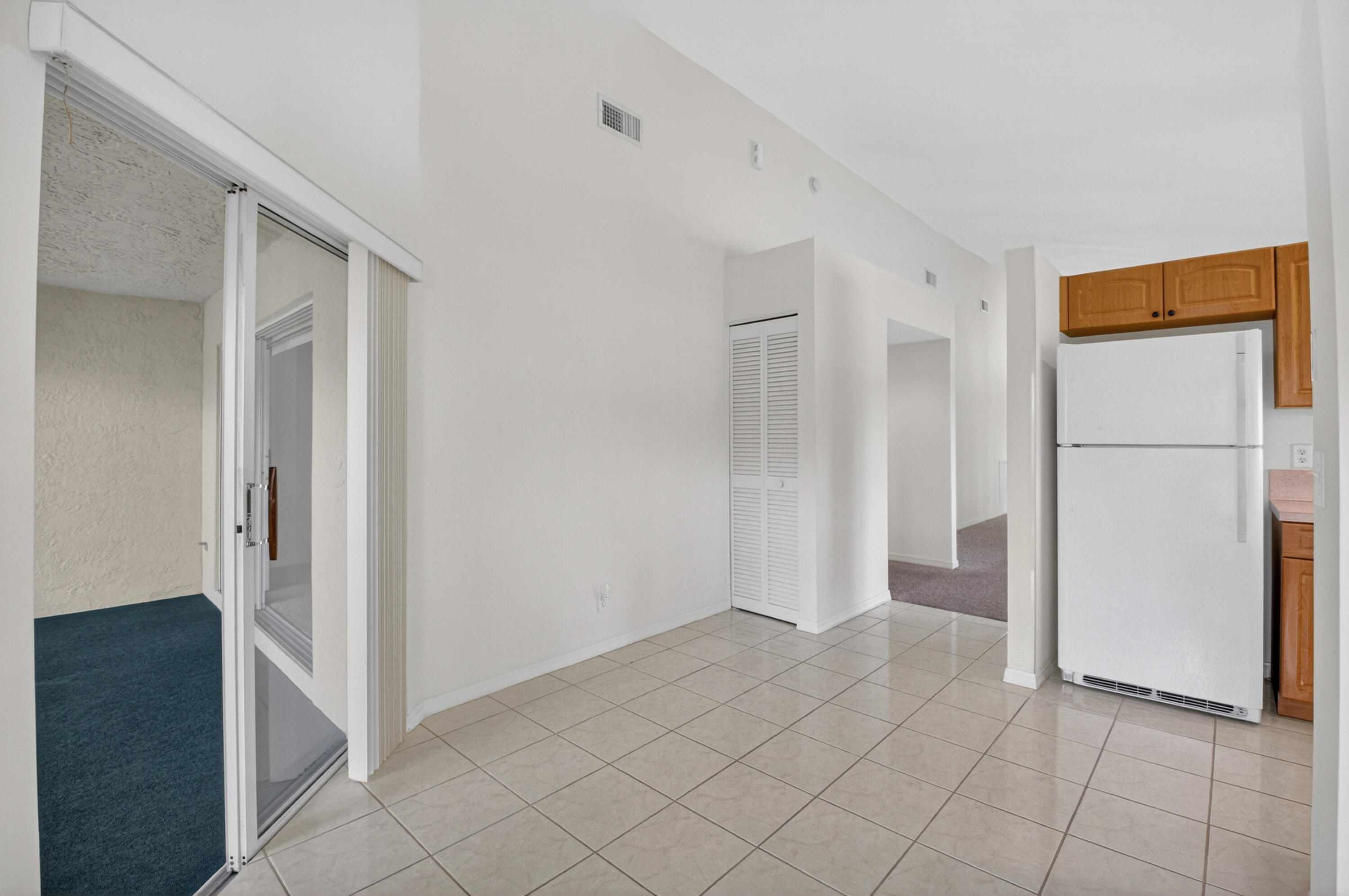 11151 Autoro Court Boca Raton, FL 33498 - Photo 16 of 70 a view of a kitchen with a refrigerator and more cabinets