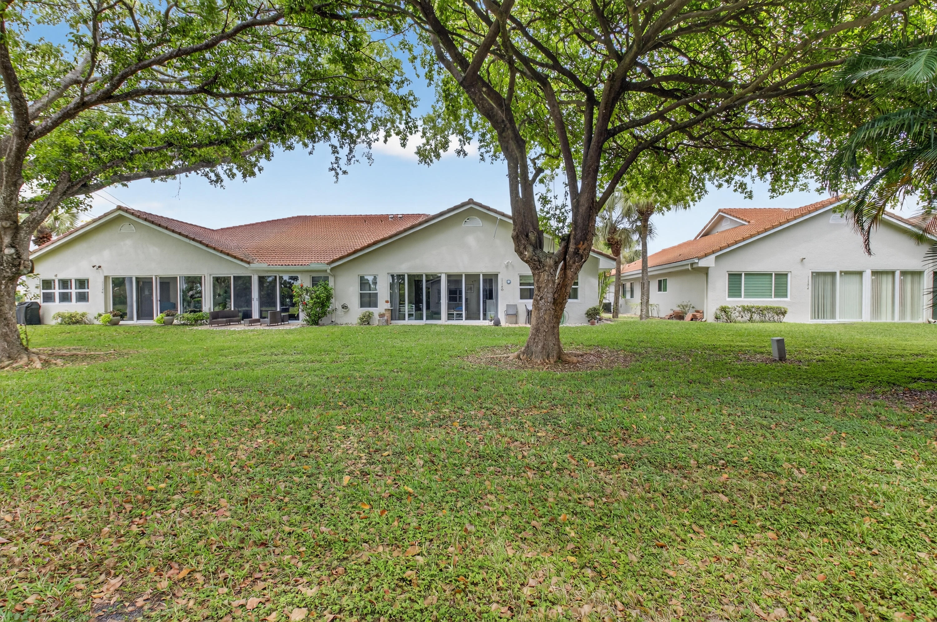 11151 Autoro Court Boca Raton, FL 33498 - Photo 3 of 70 a front view of a house with yard and green space