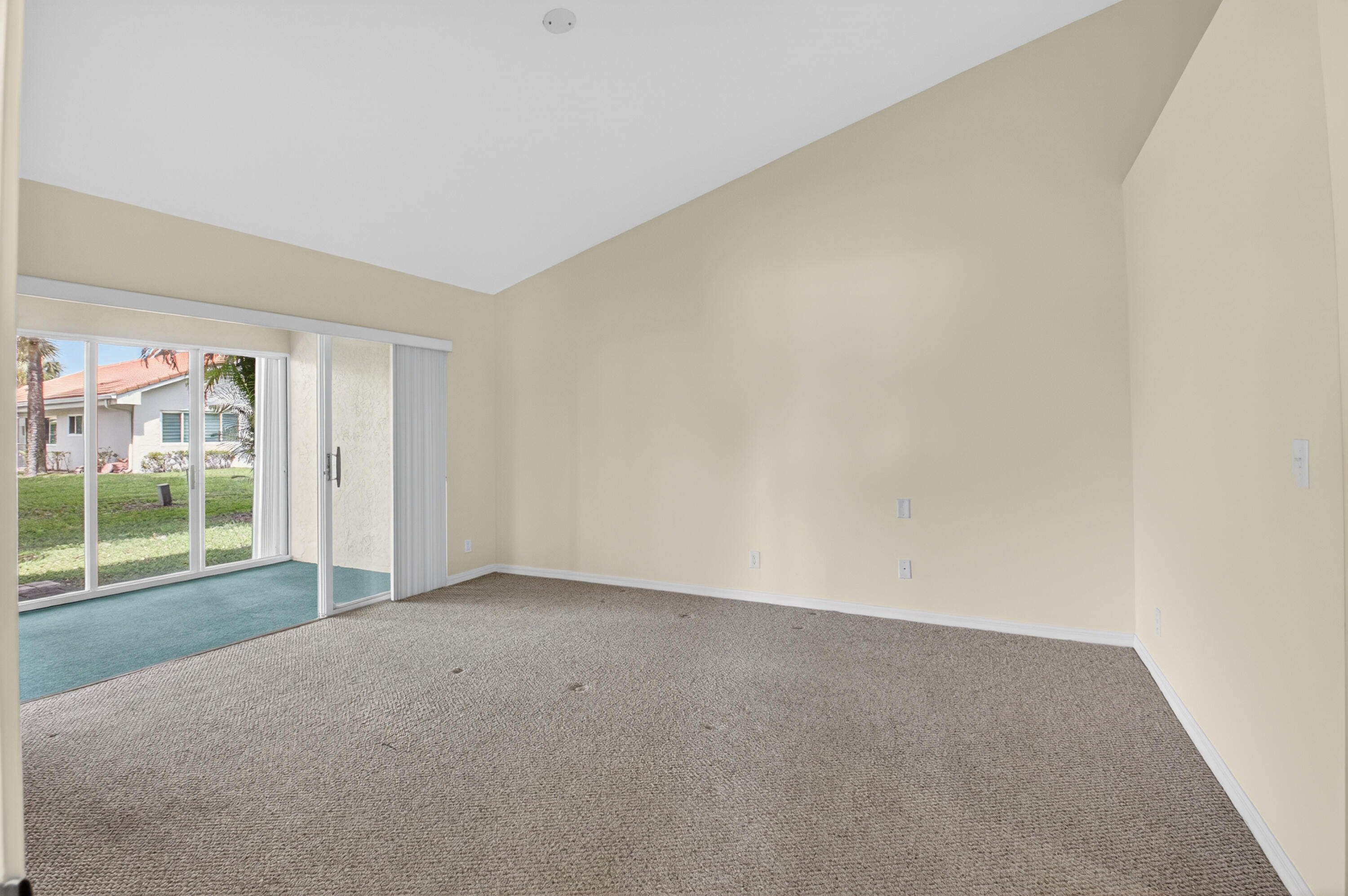 11151 Autoro Court Boca Raton, FL 33498 - Photo 31 of 70 an empty room with sliding door and wooden floor