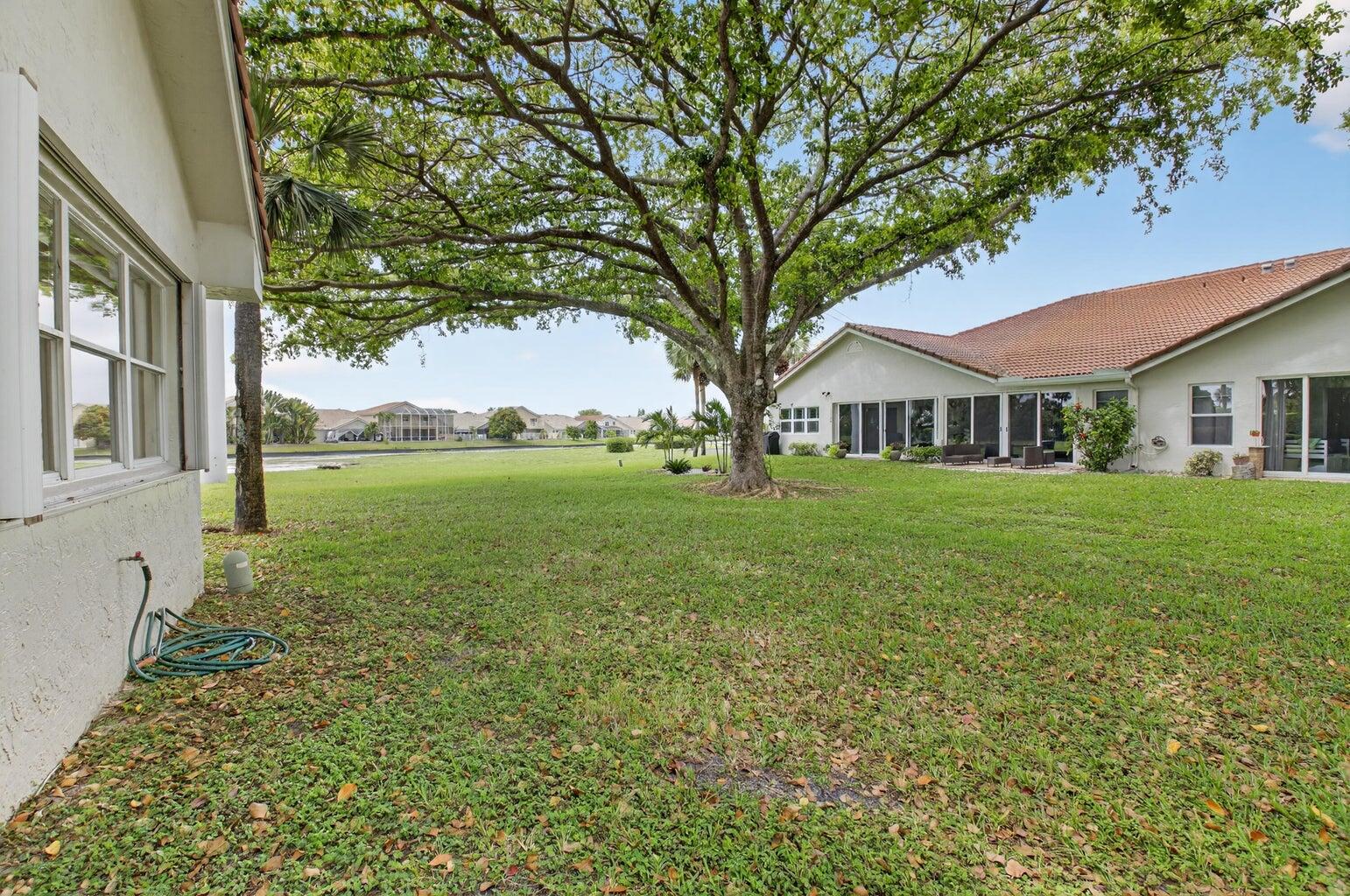 11151 Autoro Court Boca Raton, FL 33498 - Photo 4 of 70 a house view with garden space and trees