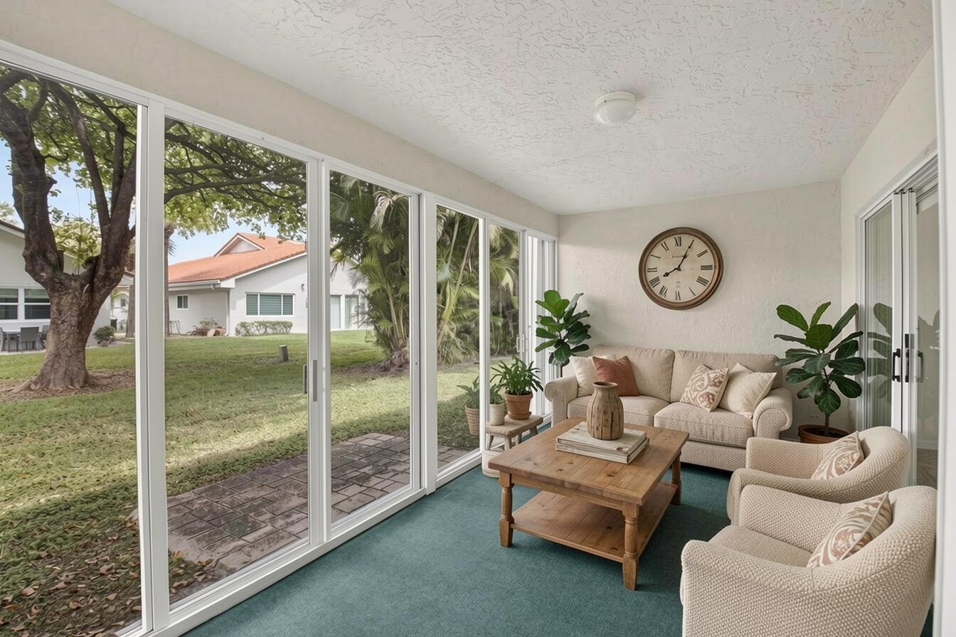 11151 Autoro Court Boca Raton, FL 33498 - Photo 44 of 70 a living room with furniture a large window and a clock