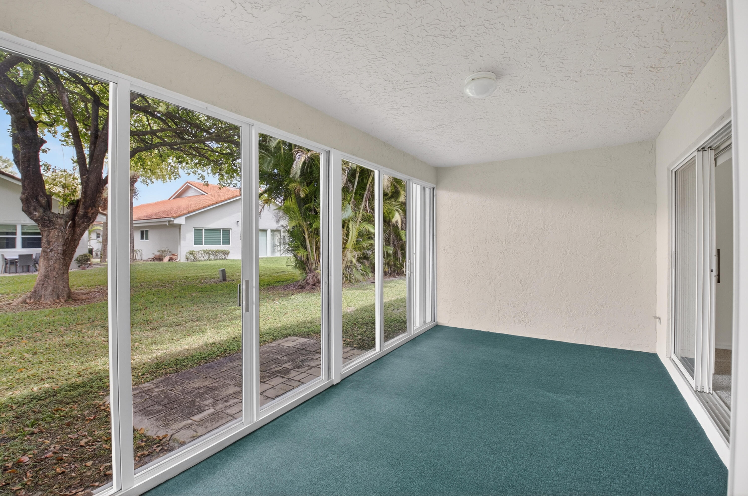 11151 Autoro Court Boca Raton, FL 33498 - Photo 45 of 70 a view of an empty room with wooden floor and balcony
