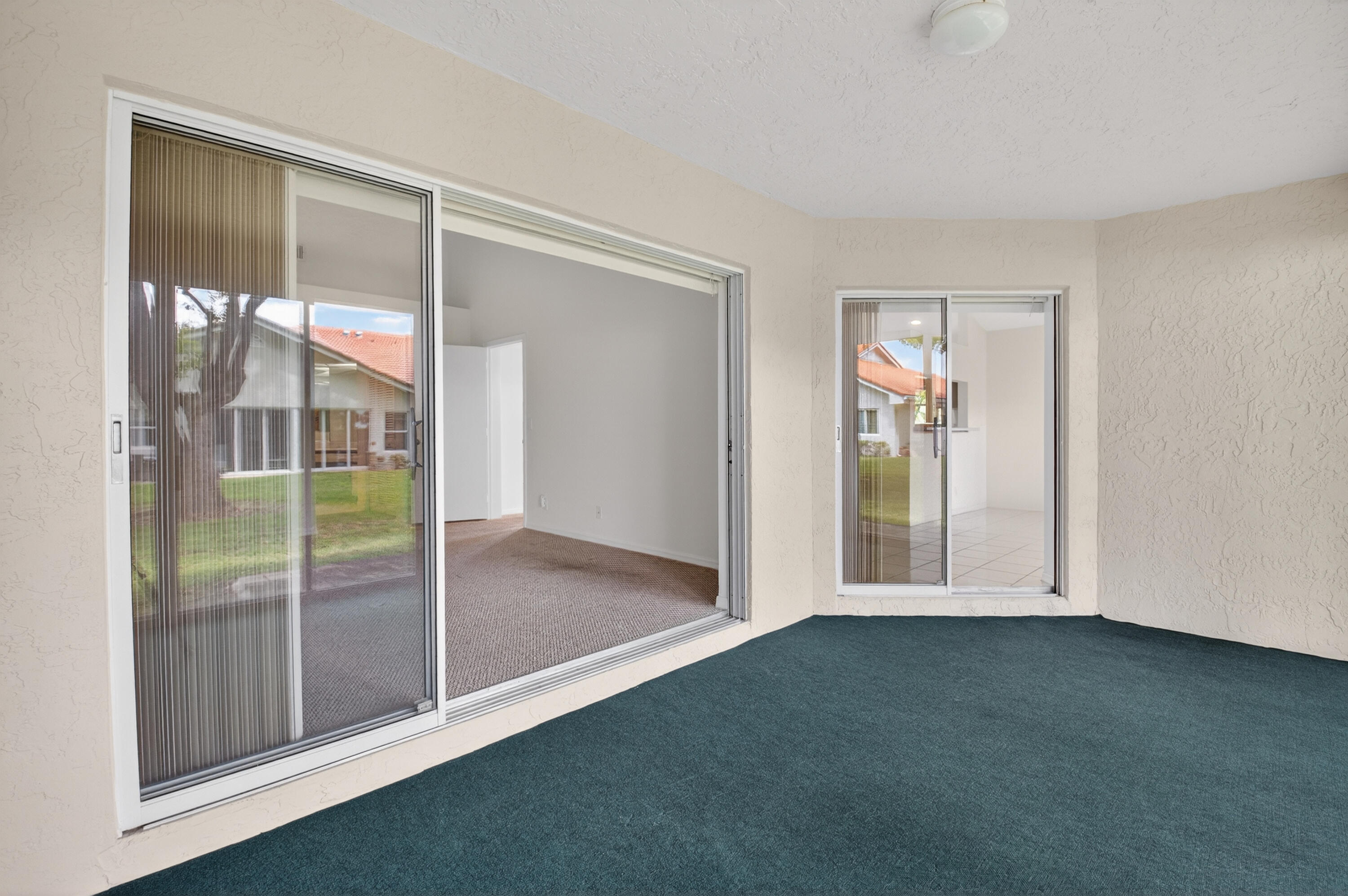11151 Autoro Court Boca Raton, FL 33498 - Photo 47 of 70 an empty room with sliding glass door and mountain view