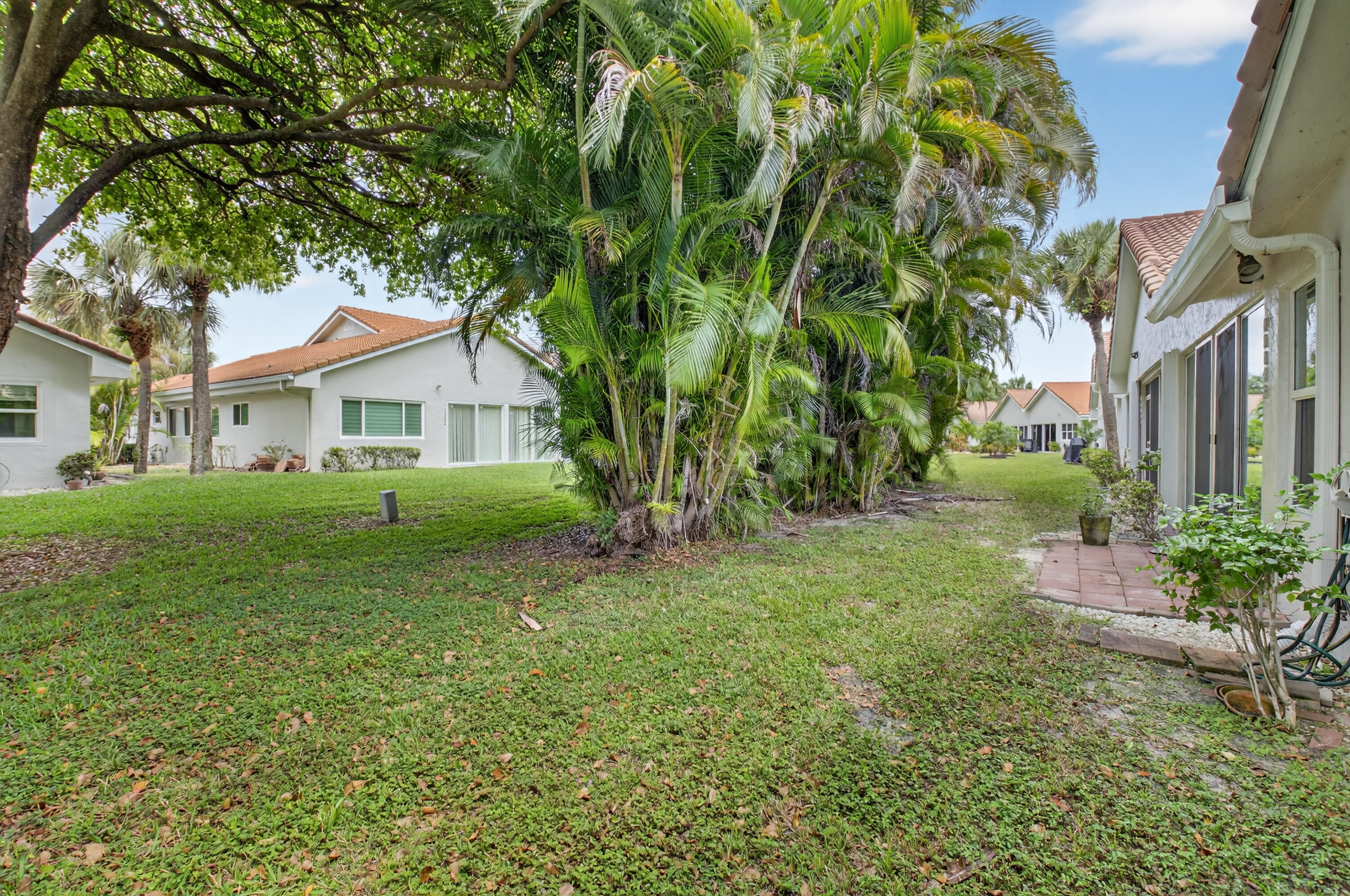 11151 Autoro Court Boca Raton, FL 33498 - Photo 50 of 70 a view of an house with backyard space and garden