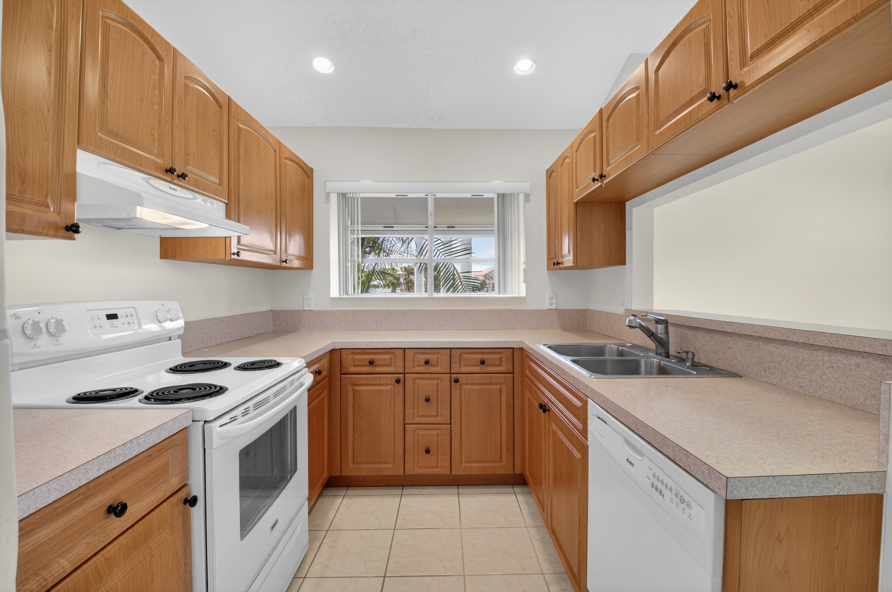 11151 Autoro Court Boca Raton, FL 33498 - Photo 6 of 70 a kitchen with a sink stove and cabinets