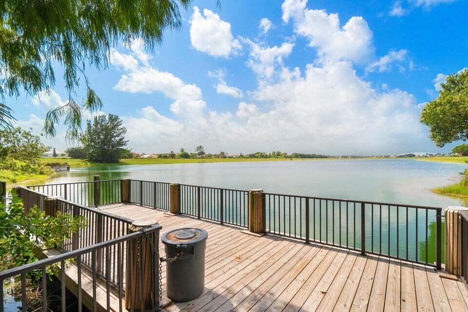 11151 Autoro Court Boca Raton, FL 33498 - Photo 69 of 70 a balcony with wooden floor and lake view