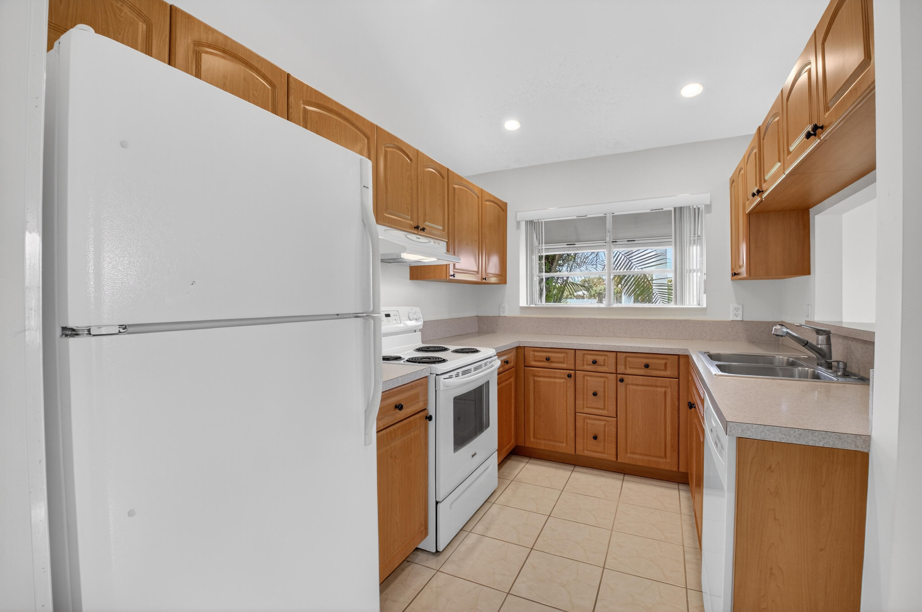 11151 Autoro Court Boca Raton, FL 33498 - Photo 8 of 70 a kitchen with stainless steel appliances granite countertop a stove a sink and a refrigerator