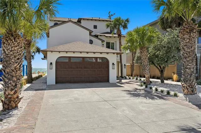 a view of a house with a yard and tree s