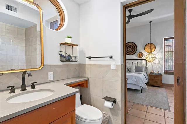 a bathroom with a bathtub a sink a vanity and a glass door shower