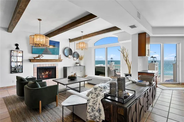 a living room with fireplace furniture and a large window