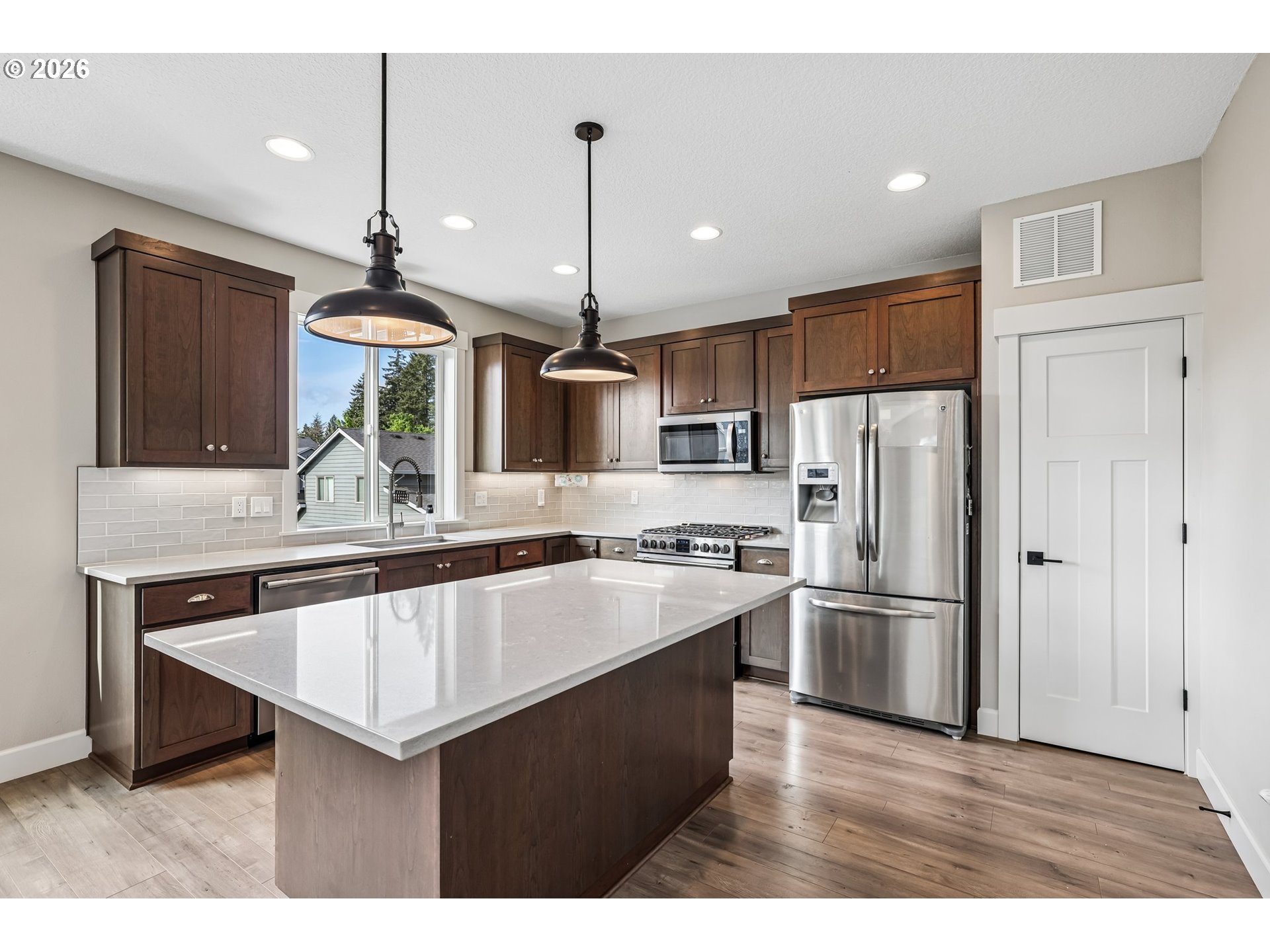 38320 Sequoia Street Sandy, OR 97055 - Photo 11 of 33 a kitchen with stainless steel appliances a sink a stove a refrigerator and island