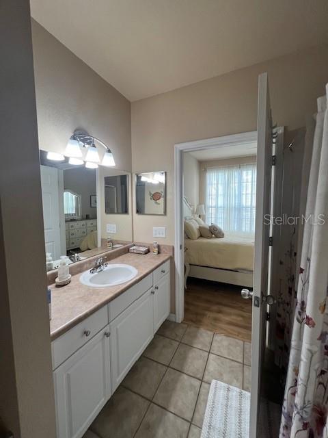 5591 Rosehill Road, Unit 102 Sarasota, FL 34233 - Photo 13 of 20 a spacious bathroom with a granite countertop sink mirror and a bathtub