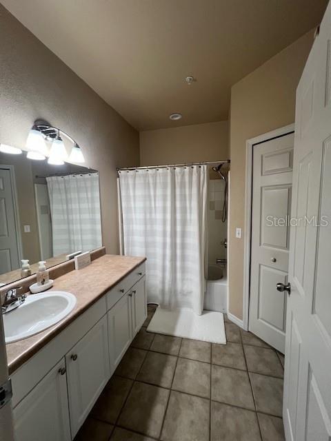 5591 Rosehill Road, Unit 102 Sarasota, FL 34233 - Photo 14 of 20 a bathroom with a granite countertop sink a mirror and a shower