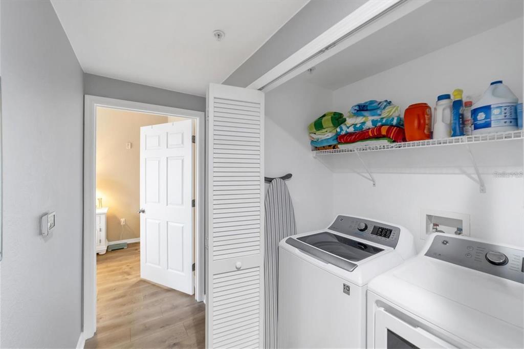 5591 Rosehill Road, Unit 102 Sarasota, FL 34233 - Photo 16 of 20 a view of storage and utility room with washer and dryer