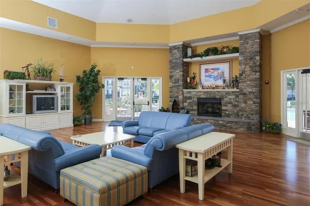 a living room with furniture a flat screen tv and a fireplace