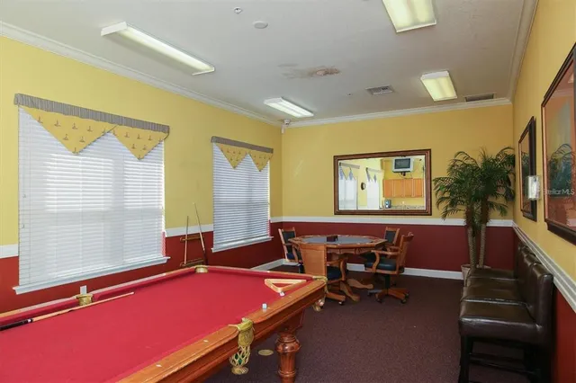 a living room with furniture pool table and a large window