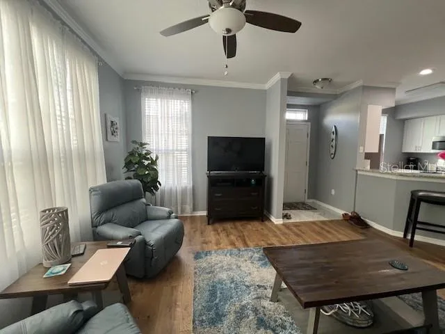 a living room with furniture and a flat screen tv