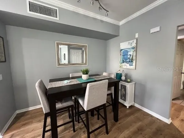 a dining room with a wooden table and chairs