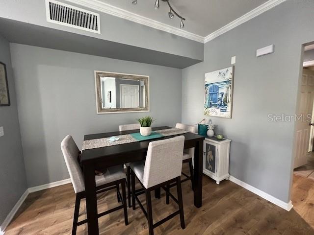 5591 Rosehill Road, Unit 102 Sarasota, FL 34233 - Photo 9 of 20 a dining room with a wooden table and chairs