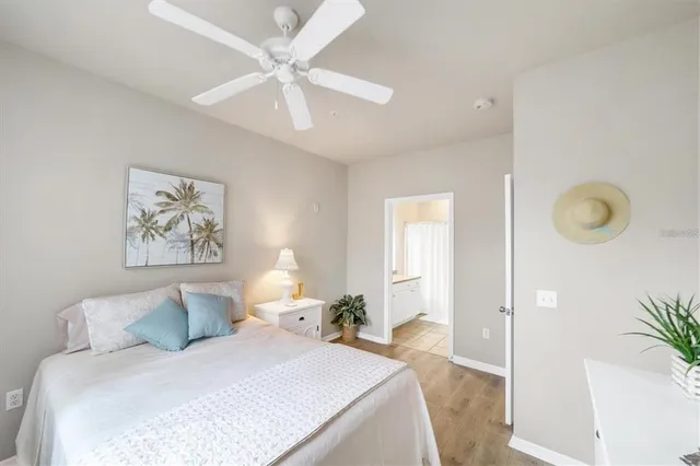 a bedroom with a large bed and a chandelier