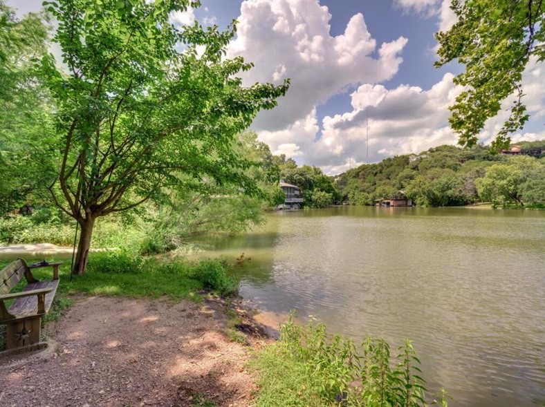 a view of a lake with houses in the back